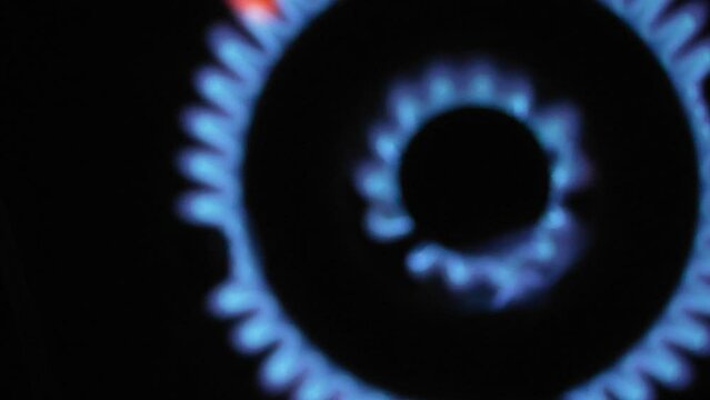 igniting the indoor gas stove kitchen burner. Top-Down Come into Focus.mp4