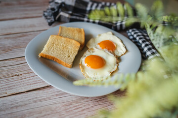 A top down and side view of eggs on the plate with toast bread on the side for breakfast clean meal healthy food 