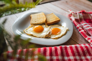 Fototapeta premium A top down and side view of eggs on the plate with toast bread on the side for breakfast clean meal healthy food 
