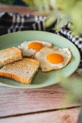 A top down and side view of eggs on the plate with toast bread on the side for breakfast clean meal healthy food 