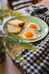 A top down and side view of eggs on the plate with toast bread on the side for breakfast clean meal healthy food 
