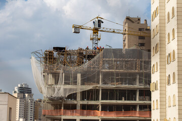 Crane on a job site in São Paulo, Brazil. With blue sky in the background