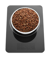 Modern kitchen scale with bowl of raw buckwheat isolated on white