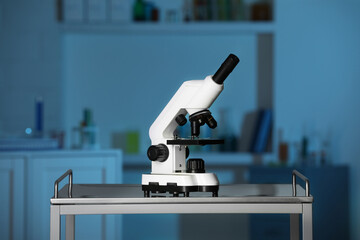 Modern medical microscope on metal table in laboratory