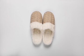Pair of beautiful soft slippers on white background, top view