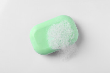 Soap with fluffy foam on white background, top view