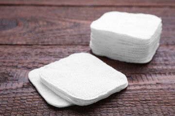 Obraz na płótnie Canvas Clean cotton pads on wooden table, closeup