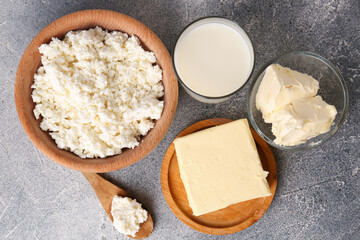 Tasty homemade butter and dairy products on grey table, flat lay