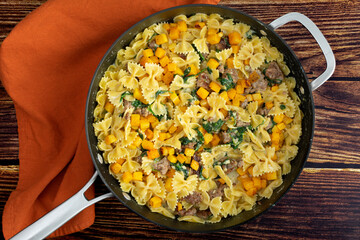 Creamy Roasted Butternut Squash Pasta with Sausage and Spinach in a Saute Pan: Skillet full of comfort food made winter squash in a cream sauce