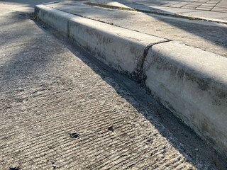 Concrete road with pavement and evening sunlight.