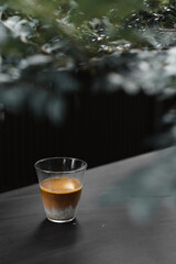 Dirty Coffee - A glass of espresso shot mixed with cold fresh milk in coffee shop cafe and restaurant