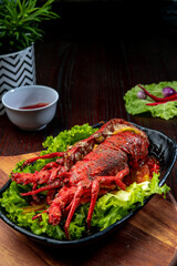 grilled lobster on a plate with salad