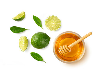 Slice of fresh lime with honey in glass bowl on white background. top view