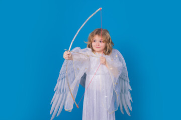 Angel with bow and arrow. Valentine's day. Blonde cute child with angel wings on a blue isolated...