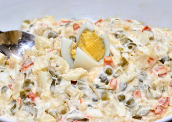 russian potato salad olivieh served in a dish