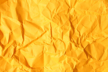 Texture of orange crumpled paper as background, closeup