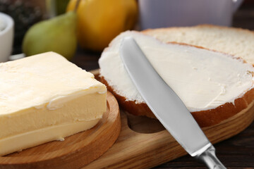 Tasty homemade butter, bread slices and tea on wooden table, closeup