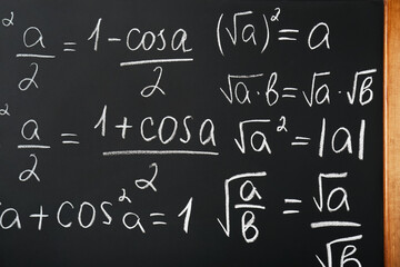 Fototapeta na wymiar Different mathematical formulas written with chalk on blackboard