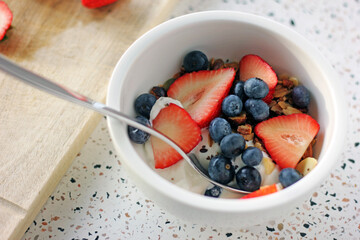 Granola with strawberries and blueberries