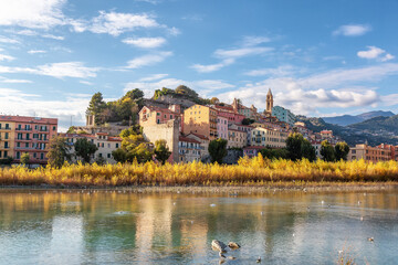 Obraz premium Old Residential Homes near river and sea in Ventimiglia, Italy. Sunny Fall Season.