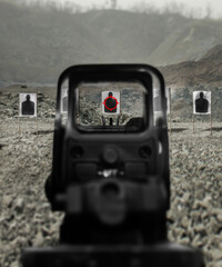 Assault rifle red dot target view, image of a rifle scope sight used for aiming with a assault...