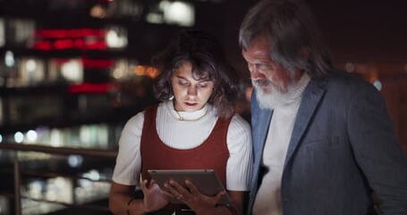 Business team, tablet and night on city building rooftop talking global networking, digital marketing and social media. Man and woman with 5g network on mobile stock market app for innovation idea - Powered by Adobe