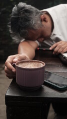 tired person try to drink coffee for push adrenaline back to work