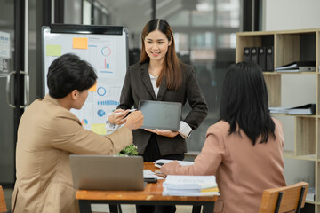 Group of asian business people working, discussing new projects together, having fun at the office.