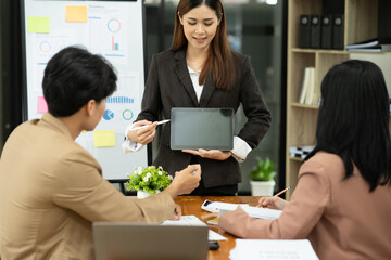 Group of asian business people working, discussing new projects together, having fun at the office.