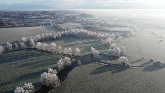 Further aerial footage of a hoar frost over Dedham Vale moving towards Dedham church and village in the distance.
