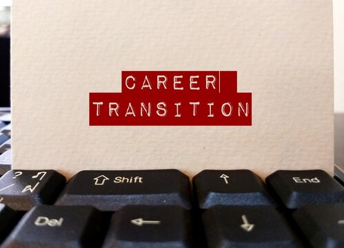 Keyboard with card paper written CAREER TRANSITION, means changing jobs or being relocated or jumping into a new career, need to overcome fear and get out of comfort zone