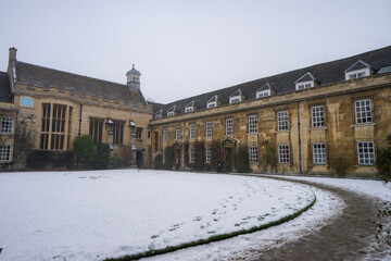 Fototapeta na wymiar Christ College near St.John’s College , Nice buildings architecture during winter snow at Cambridge , United Kingdom : 3 March 2018