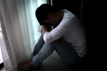 man sitting in the corner of the room have emotional and mental problems He has depression and stress from society and work. medical concept