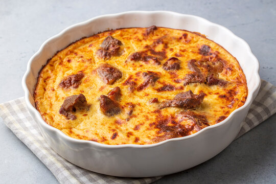 Tave kosi is a national Albanian dish of baked lamb and rice with yoghurt close-up in a pan on the table. horizontal top view from above. Turkish name; Elbasan tava