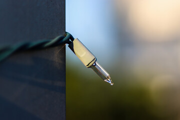 Holiday light on a metal flag pole 