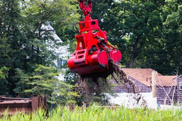Dredging waterway along the river with heavy machinery 