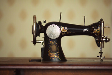 Retro concept. Close up of front side of vintage sewing machine in dress atelier. Indoor shot