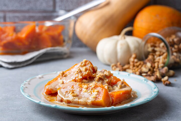 Pumpkin dessert with tahini and walnuts on a white porcelain plate