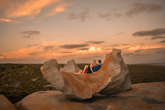 Couple Laying Together On Rock Watching Sunset