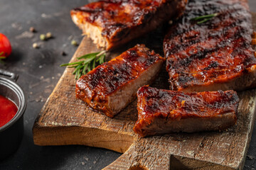 Barbecue chuck beef ribs with hot rub sliced on a wooden cutting board, Food recipe background....