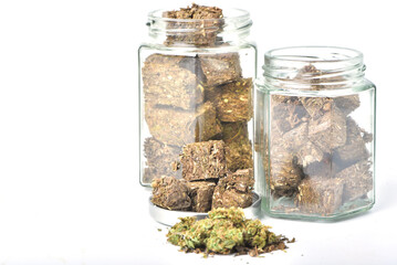 Dried marijuana in a jar on a white background. Medical marijuana dispensary Alternative medicine Cannabis plantation for medical and business concept.