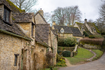 Arlington Row in Bibury , classic villages in Cotwolds wonderful stone buildings and river coln during winter cloudy day at Gloucestershire , United Kingdom : 6 March 2018