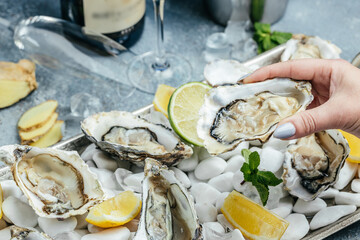 Fresh oysters on ice with lemon. Healthy food, gourmet food. Oyster dinner in restaurant