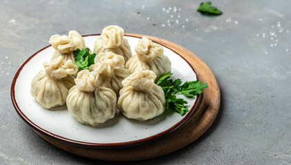 Khinkali with meat on plate. Restaurant menu, dieting, cookbook recipe top view