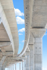 Elevated expressway foundation structure in under construction against blue sky in vertical frame