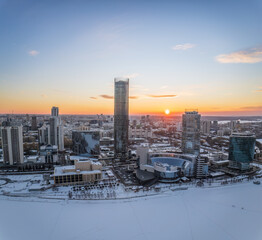 Yekaterinburg city with Buildings of Regional Government and Parliament, Dramatic Theatre, Iset Tower, Yeltsin Center, panoramic view at winter sunset.