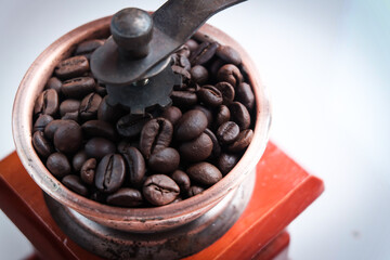 Coffee beans in manual wooden hand grinder