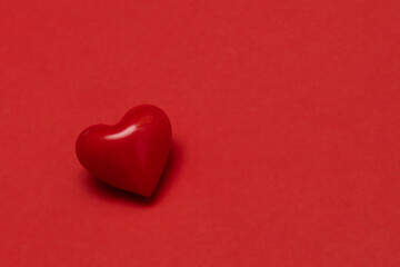 Valentines day red heart on same color background. Monochromatic vivid color. Valentine's day concept. Close up, copy space.