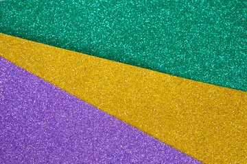 Mardi gras festive traditional color background. Abstract shiny background gold, green, purple....