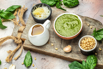 Green basil pesto with italian recipe ingredients, Basil, olive oil, parmesan, garlic, pine nuts. banner, menu, recipe place for text, top view
